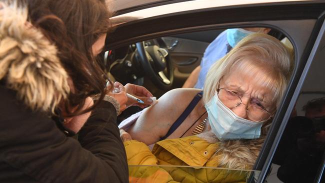 A woman receives the coronavirus vaccine at a drive-through centre in Manchester. Picture: AFP