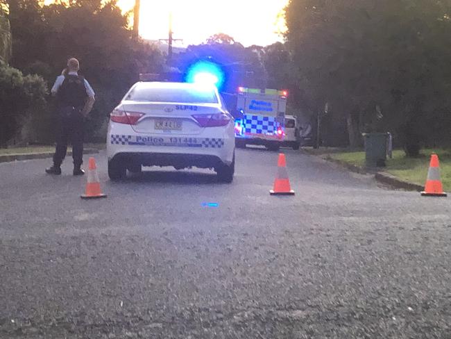 Police block the road at the scene of a multiple stabbing incident at Goonellabah.