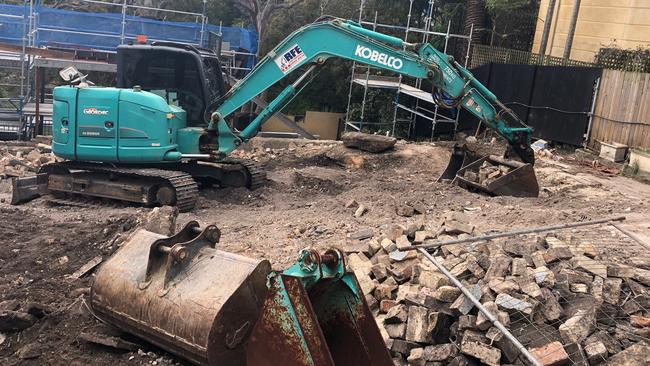 The excavator on a building demolition site on North Harbour St, Balgowlah, that uncovered a human skull. Picture: Jim O'Rourke