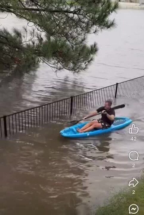 Man paddles in front yard floods