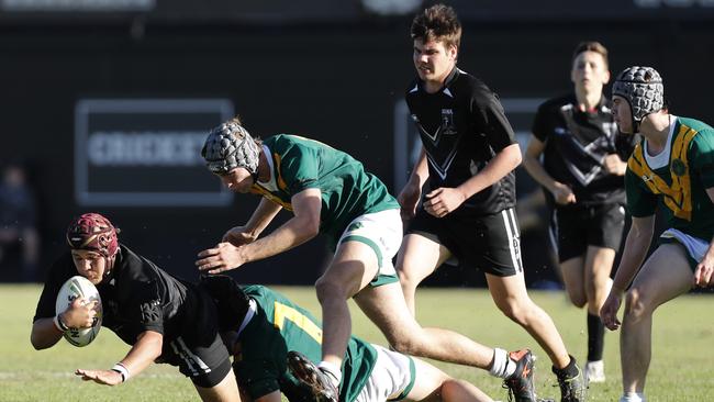 Typically good defence from Nick Weir (No.7) of St. Patrick's last year. This is from an AIC rugby league match, but Weir will also captain the First XV this season. (AAP Image/Regi Varghese)