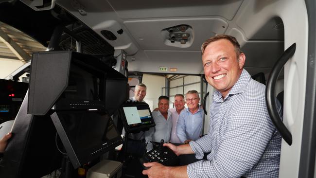 Premier Steven Miles in the police helicopter at Townsville airport with in-trouble Labor MPs in the background. Picture: Annette Dew