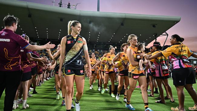 Katie Brennan of the Tigers and Greta Bodey of the Hawks lead the teams onto the grounds ahead of the round eight AFLW match between Hawthorn Hawks and Richmond Tigers at Cazaly's Stadium, on October 20, 2023, in Cairns, Australia. (Photo by Emily Barker/Getty Images)