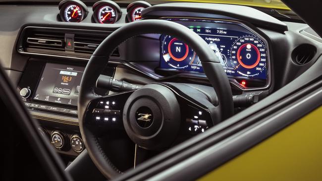 An old-school analogue gauge pod joins a digital dashboard and central touchscreen.