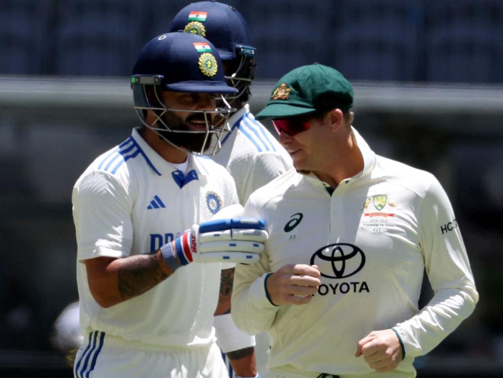 Kohli chats with Steve Smith as he walks to the pavilion after his dismissal. Picture: COLIN MURTY / AFP