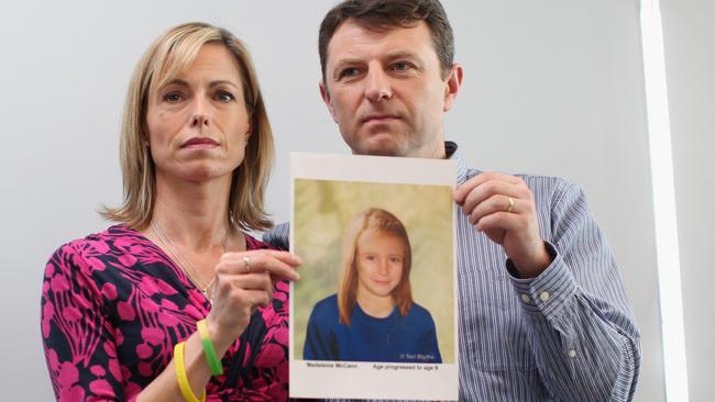 A 2012 photo of Kate and Gerry McCann holding an age-progressed police image of their daughter to mark the fifth anniversary of her daughter’s disappearance. Picture: Dan Kitwood/Getty Images.