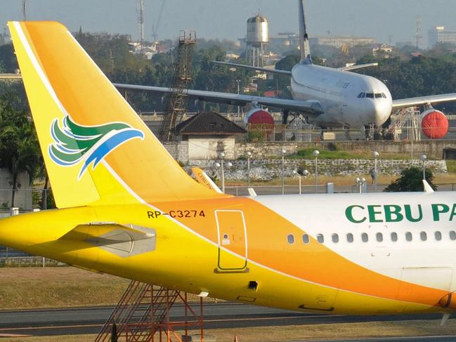 (FILES) This file photo taken on March 13, 2014 shows a Cebu Pacific Airbus A320 aircraft parked on the tarmac at Manila's international airport. The Philippines' largest airline on March 26, 2015 reported a 67-percent rise in profits last year, with strong growth in domestic passenger numbers and swift success on a new Australia route. Cebu Pacific posted a net profit of 19 million USD (853 million pesos) in 2014, up from 512 million pesos in 2013. AFP PHOTO / FILES / Jay DIRECTO