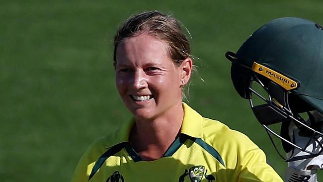 (FILES) In this file photo taken on March 22, 2022 Australia's captain Meg Lanning celebrates after reaching her century (100 runs) during the Women's Cricket World Cup match between Australia and South Africa at the Basin Reserve in Wellington on March 22, 2022. - Waiting tables in her local cafe and hanging out with friends and family helped rekindle Meg Lanning's love of cricket and intensified her drive to steer top-ranked Australia to another Twenty20 World Cup title this month.The decorated women's skipper took a indefinite months-long hiatus in 2022 after an intense few years, sparking fears she would not return. (Photo by Marty MELVILLE / AFP)