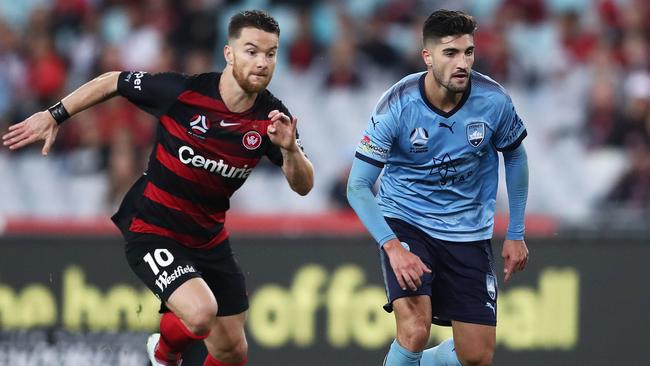 Sydney FC’s Paulo Retre is challenged by Western Sydney Wanderers’ Alexander Baumjohann on Saturday night. Picture: Getty Images