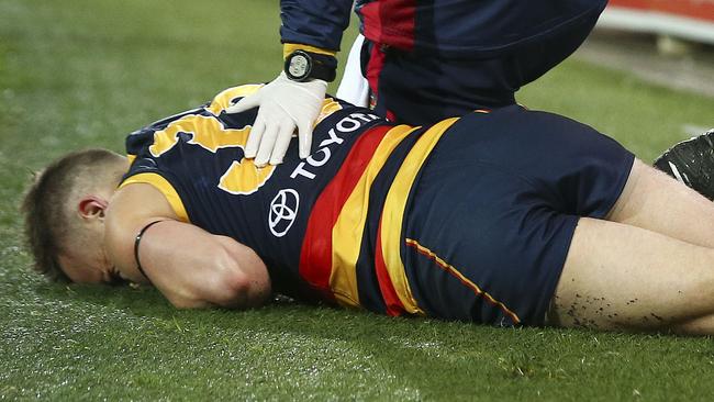 Brodie Smith down after sliding on the fake turf and rupturing his ACL. Picture SARAH REED