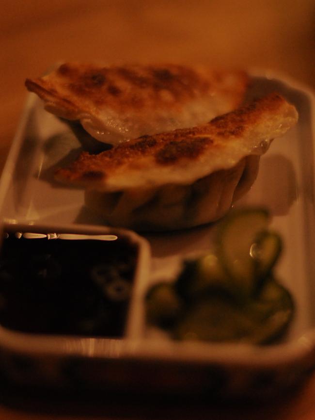 Salmon and garlic chive gyoza with citrus soy dipping sauce.