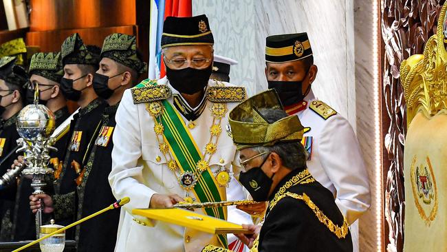 Malaysian King Sultan Abdullah Sultan Ahmad Shah receives documents from Prime Minister Ismail Sabri Yaakob during the opening of parliamentary sessions in Kuala Lumpur last week. Picture: AFP