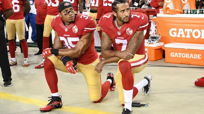 Colin Kaepernick #7 and Eric Reid #35 of the San Francisco 49ers kneel in protest during the national anthem.