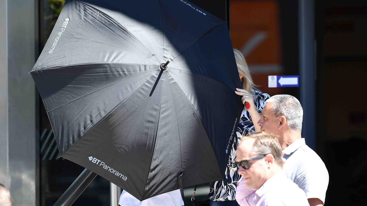 Riley Filip Cantarella (left) used an umbrella to shield his face as he left court on Tuesday with supporters. Picture: Patrick Woods