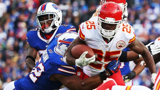 Jamaal Charles breaks a tackle by Preston Brown.