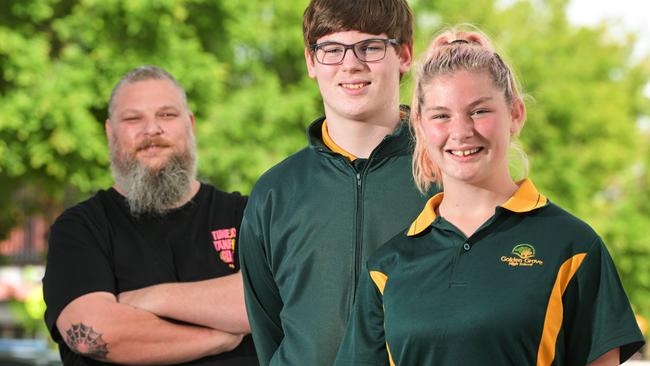 Golden Grove High School students Brock and Isabelle St Clair with their father Steven at school pick-up on Monday. Picture: Brenton Edwards