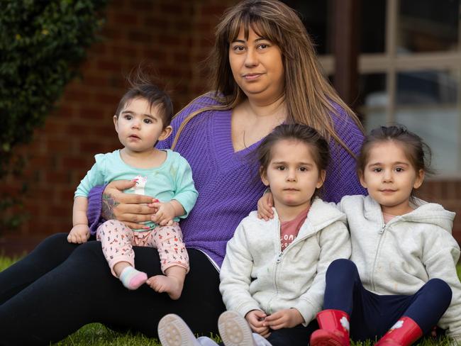 Mum Rhiannon Caspersz with her children Scarlette and Trixie, 3 and Mailea,7 months.Rhiannon is a mother of three daughters - two twins who are three-years-old and a seven-month-old. They're all living in one bedroom of her parent's home after moving out of a rental which Rhiannon said was unsafe for her kids. Picture: Jason Edwards