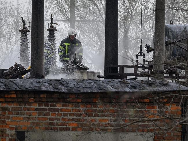 A firefighter surveys the damage at traction substation building near rail lines, which officials said were the target of a Russian missile attack near Lviv, Ukraine. Picture: Getty Images