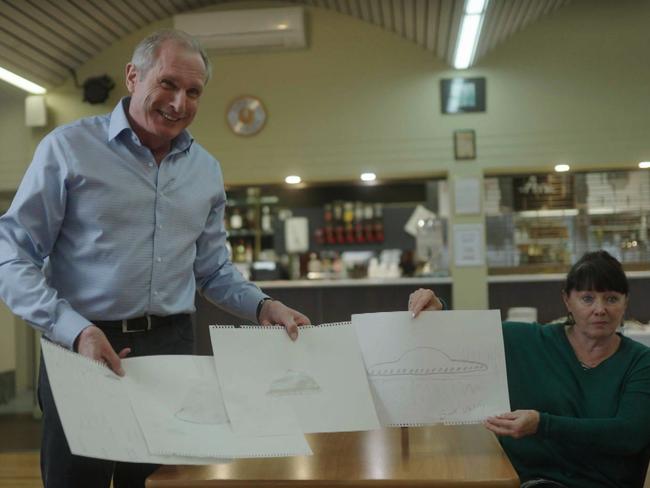 A shot from the 7NEWS Spotlight on UFO Sightings, showing Ross Coulthart with Terry Peck holding drawings from witnesses in Westall. Picture: Supplied