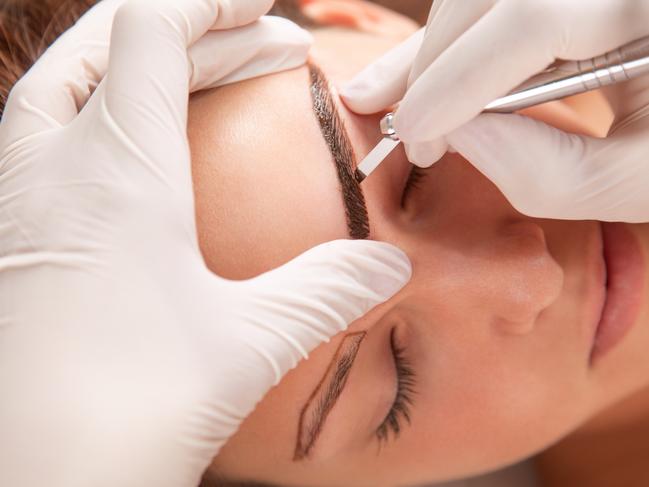 A young woman is receiving eyebrow treatment. Picture: iStock.