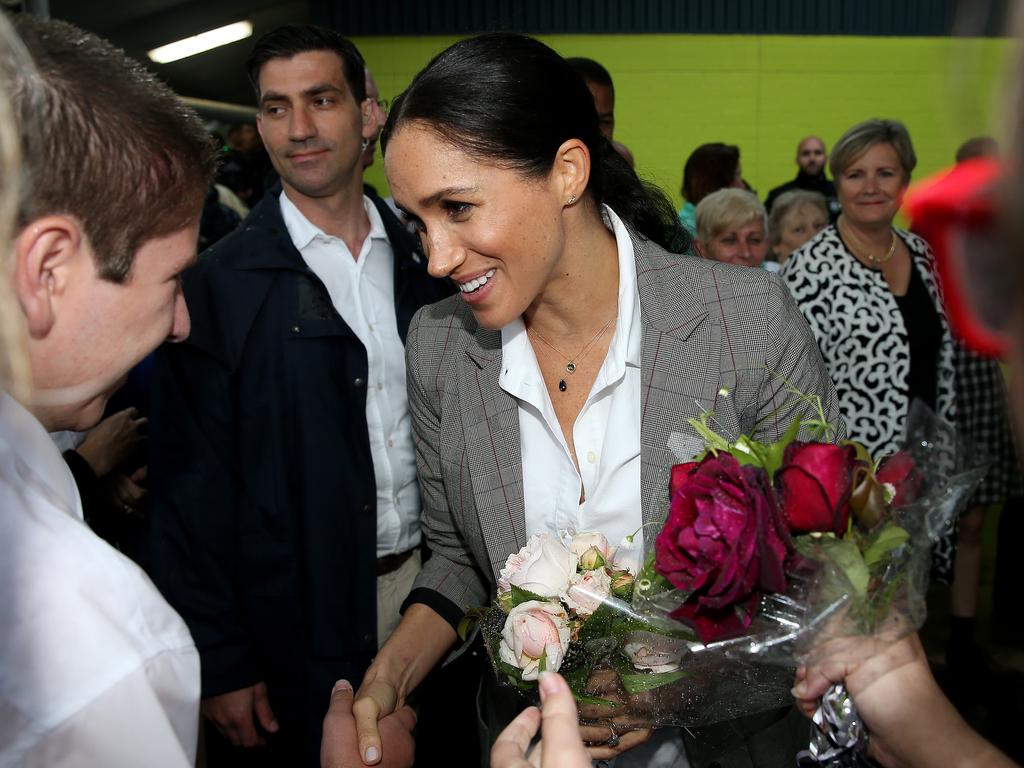 Meghan accepts some flowers from a student. Picture: Toby Zerna