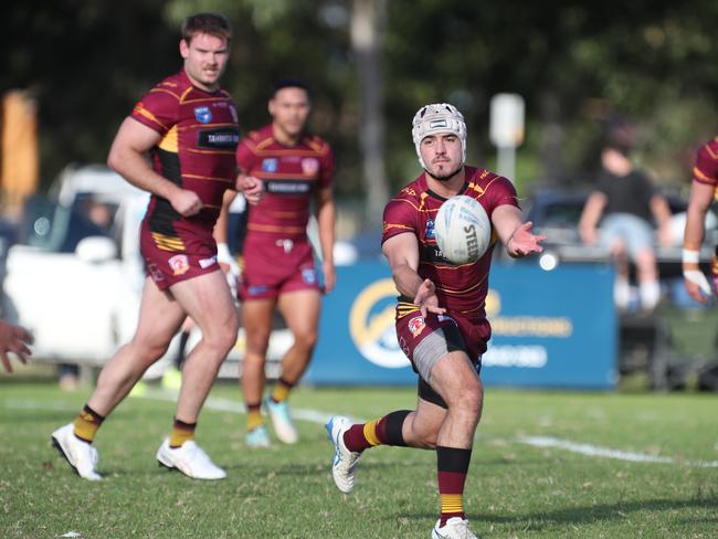 Joey Towerton fires off a pass as Kye Madden watches on. Picture Warren Gannon Photography