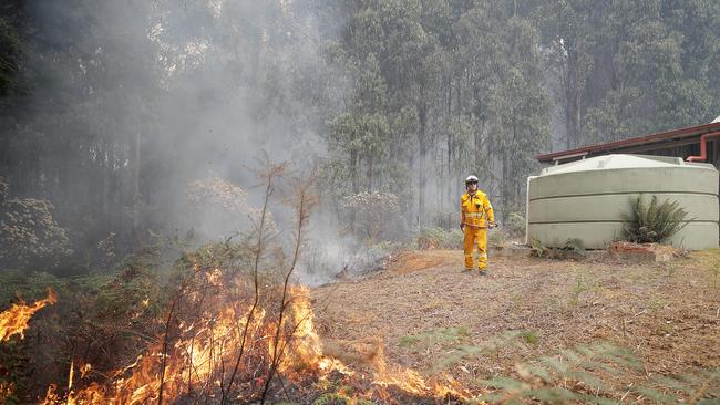 TFS crews conduct a controlled burn in Donnelly's Road, Geeveston to protect a house. Picture: RICHARD JUPE