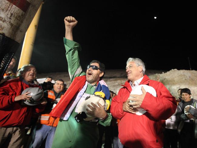 Chilean miner Luis Urzua (gestures alongside President Sebastian Pinera after reaching the surface from the San Jose mine, near Copiapo, Chile on October 13, 2010. Picture: AFP Photo/Hugo Infante 