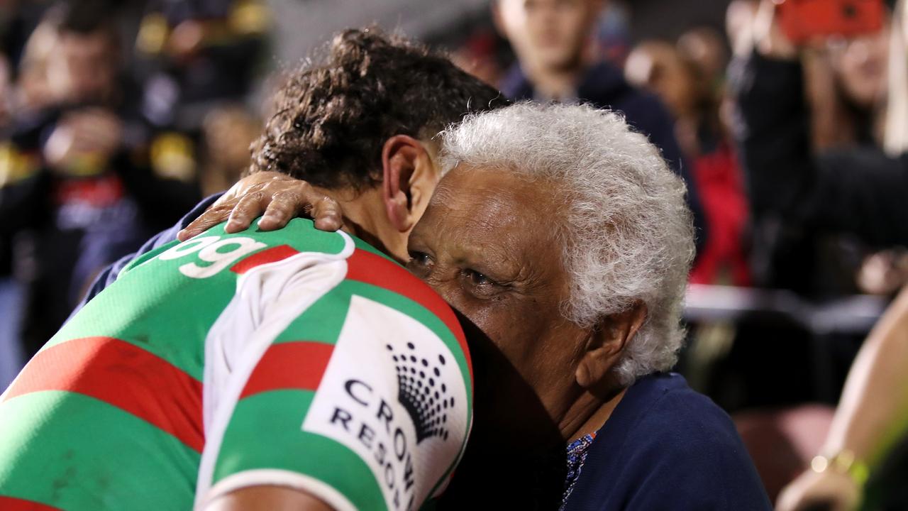 Latrell Mitchell gives a hug to the supporter who was hit in the face be a wayward kick. Picture: Getty