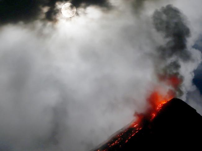 Lava is seen flowing out of a volcanic ash cloud. Yellowstone is far more likely to experience devastating earthquakes than an eruption, scientists say. Picture: AP