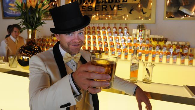 Brody Watson holds up a glass in the Johnnie Walker marquee in the Birdcage at Flemington racecourse. Picture: AAP Image/Julian Smith.