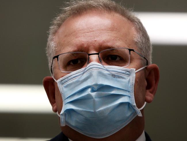 SYDNEY, AUSTRALIA - AUGUST 19: Prime Minister Scott Morrison is seen wearing a face mask during a press conference at AstraZeneca on August 19, 2020 in Sydney, Australia.  The Australian government has announced an agreement with the British pharmaceutical giant AstraZeneca to secure at least 25 million doses of a COVID-19 vaccine if it passes clinical trials.  The University of Oxford COVID-19 vaccine is currently in phase-three testing. If the vaccine proves to be successful, Australia will manufacture and supply vaccines and will be made available for free. The project could deliver the first vaccines by the end of this year or by early 2021. (Photo by Lisa Maree Williams/Getty Images)