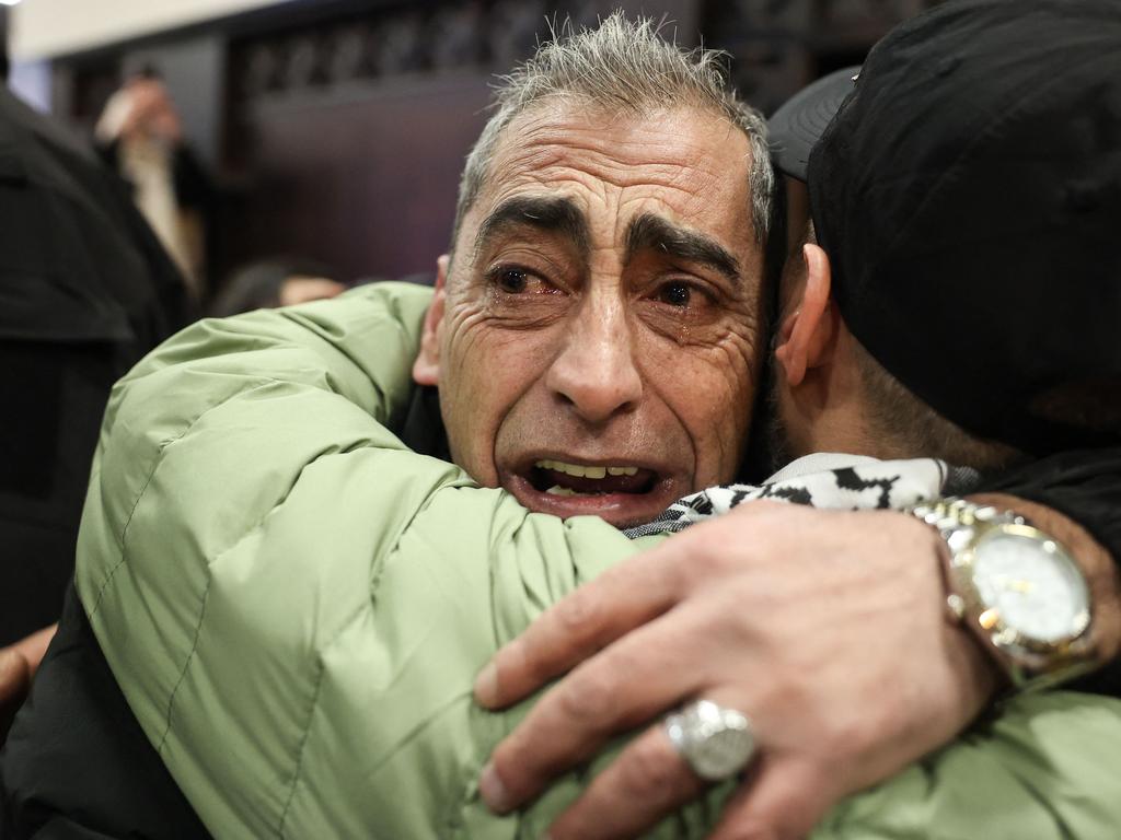 A man cries as he hugs a former Palestinian prisoner (R), released as part of the seventh hostage-prisoner exchange, upon his arrival in the occupied West Bank city of Ramallah on February 27, 2025. Picture: AFP