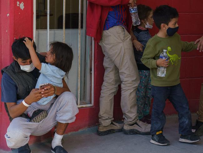 Migrants wait outside Gimnasio Kiki Romero, a gym which has been converted into a makeshift migrant shelter by the city of Juarez, after being expelled from the US to Mexico. Picture: AFP