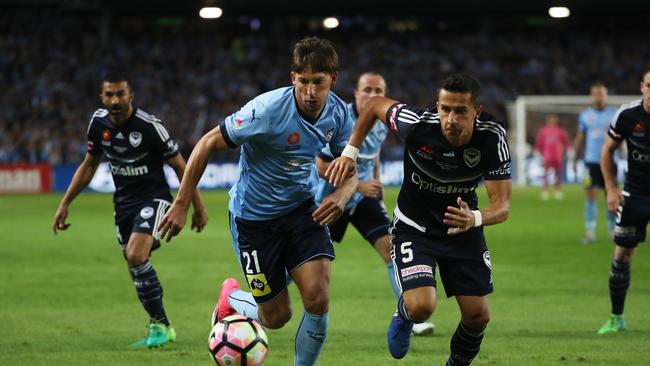 Filip Holosko of Sydney FC and Daniel Georgievski of Victory battle for the ball in the grand final. Picture: Brett Costello