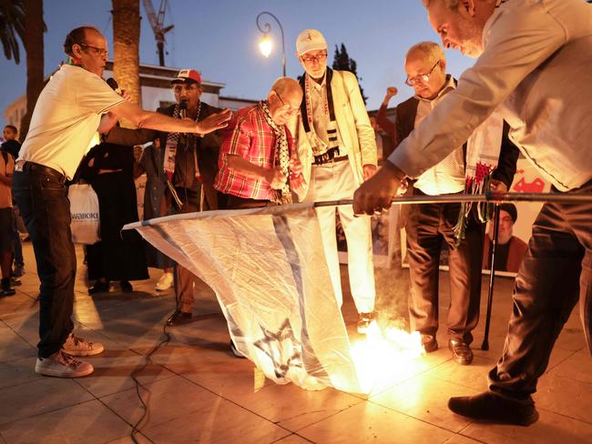 Demonstrators burn an Israeli flag in front of the parliament building, following the assassination of Lebanon's Hezbollah leader Hassan Nasrallah, in Rabat. Picture: AFP