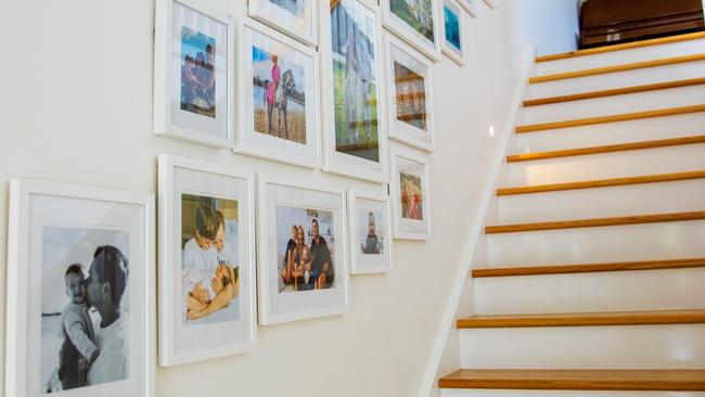 Family photos line the wall of TV presenter Liz Cantor’s Miami home. Picture: Nigel Hallett.