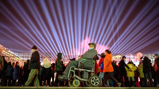 People walk on the banks of Yangtze River on New Year's Eve in Wuhan. Picture: AFP