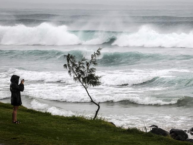 Residents watch massive waves stirred by tropical cyclone Alfred at Byron Bay's Main Beach Picture: David Gray/AFP