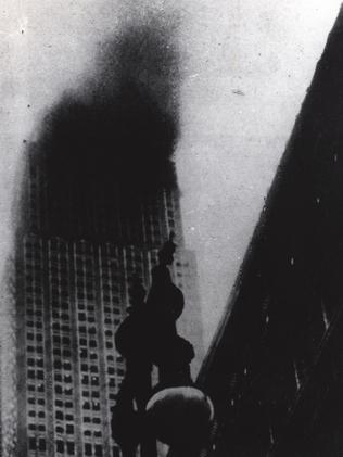 Smoke pours from the Empire State Building after the bomber flew into the 78th floor in fog.