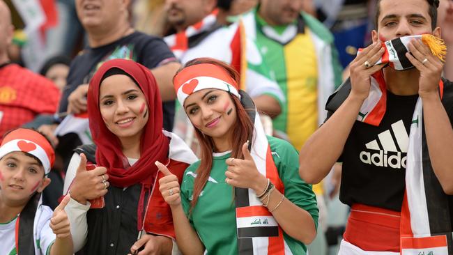 Iraq fans cheer before the start of their game against Palestine.