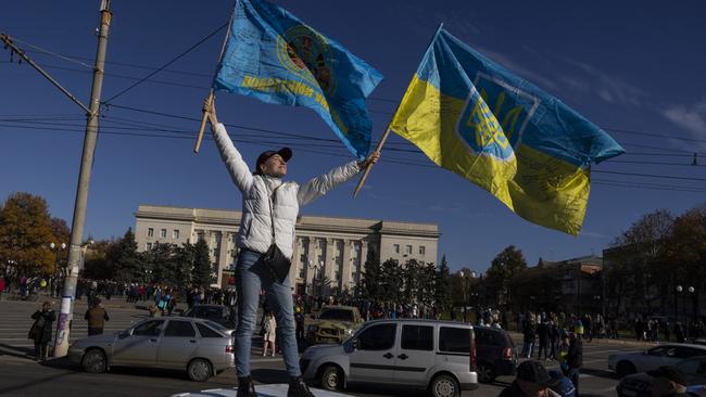 Natalia Pevnevy celebrates atop her car on Liberty Square following Ukrainian President Volodymyr Zelenksky's surprise visit to Kherson on November 14. Picture: Paula Bronstein/Getty Images