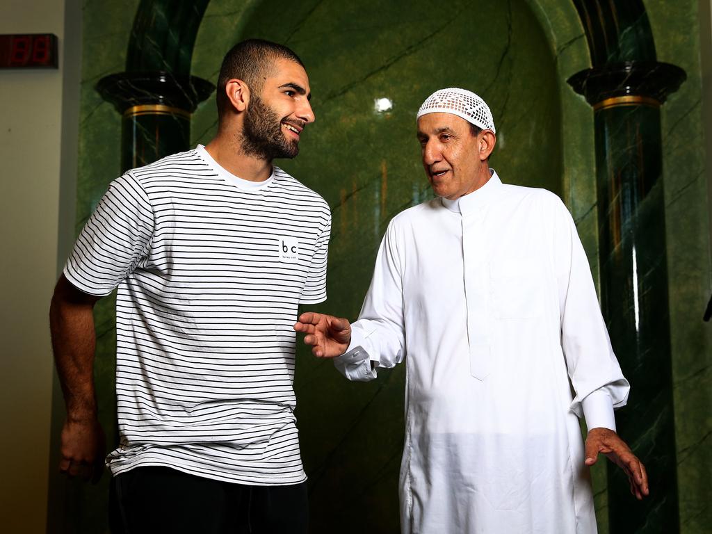 Adam Saad with Hussin Goss, President of the Gold Coast Islamic Society, during his time playing with the Suns. Picture: Adam Head