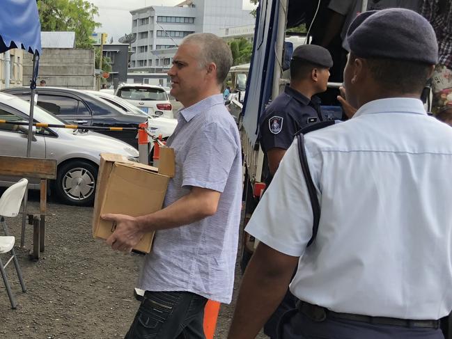 John Nikolic carrying a brown box at the Suva High Court. Picture: Varanisese Bolatagane