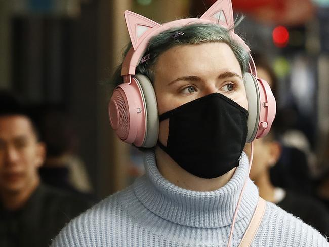 MELBOURNE, AUSTRALIA - DECEMBER 10: Some people are seen wearing face masks on Swanston Street on December 10, 2020 in Melbourne, Australia. Victoria has recorded its 41st day without any new COVID-19 cases, with no one diagnosed with coronavirus since 30 October in Victoria. Mask-wearing is now only mandatory in indoor shopping centres and public transport, including rideshares and taxis, but relaxed in other settings. Victorians must still carry a mask with them at all times and wear it when a physical distance of 1.5 metres cannot be maintained, but mask use is encouraged, but not mandatory, in other situations. Cafes, restaurants and pubs can double their patron numbers to a maximum of one person per 2 sq m and nightclubs can reopen from midnight. People are able to have up to 30 visitors at home, while outdoor gatherings can now have up to 100 people. (Photo by Daniel Pockett/Getty Images)