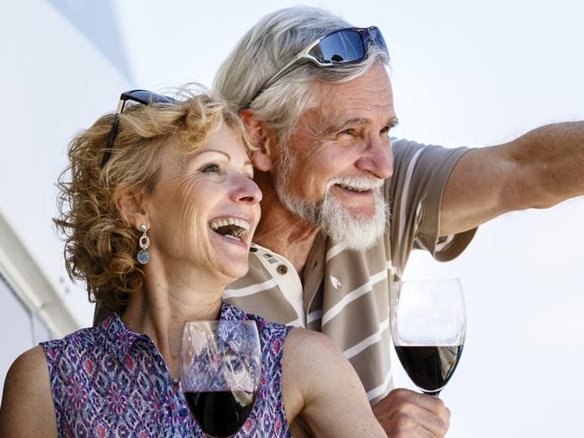 Happy senior couple enjoying wine on yacht. seniors and retirees travel, holidays, generic