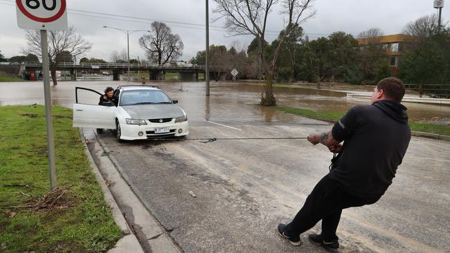 They were forced to pull the car out by hand. Picture: David Caird