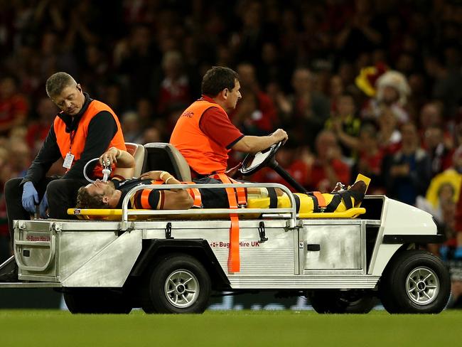 Leigh Halfpenny of Wales is stretchered off the field after suffering a knee injury.