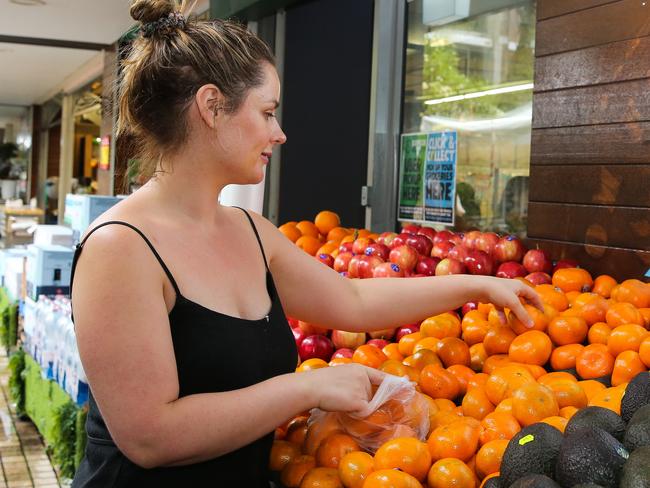 SYDNEY, AUSTRALIA -  Newswire Photos MARCH 14 2023 - A member of the public is seen buying produce and groceries in Sydney as the Cost of living continues to rise. Picture: NCA Newswire / Gaye Gerard.