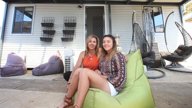 Tegan Newman, right, with the studio in which she lives, and her mum Noraine Singletary who owns the property the unit sits on. Picture: David Crosling